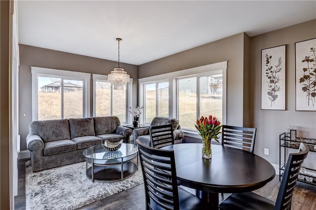6468 Aspen Ridge Dr, Eau Claire, WI 54703 - dining space with a healthy amount of sunlight, dark wood-style flooring, and an inviting chandelier