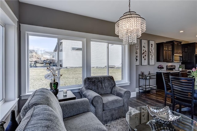 6468 Aspen Ridge Dr, Eau Claire, WI 54703 - living room featuring plenty of natural light, baseboards, dark wood-style floors, and a notable chandelier