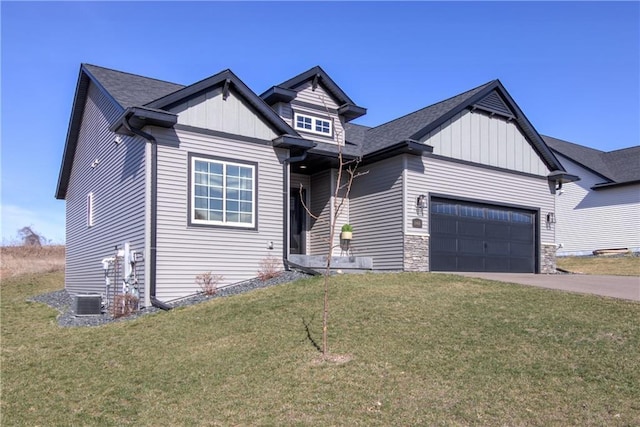 6468 Aspen Ridge Dr, Eau Claire, WI 54703 - view of front of house featuring board and batten siding, an attached garage, a front lawn, and aphalt driveway