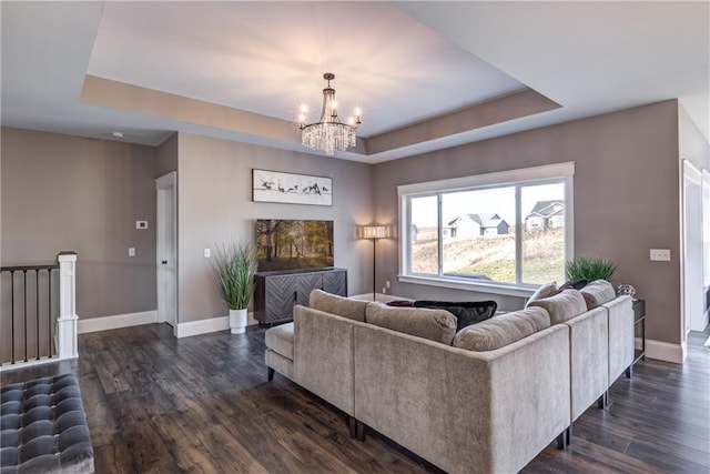 6468 Aspen Ridge Dr, Eau Claire, WI 54703 - living area featuring baseboards, a tray ceiling, an inviting chandelier, and dark wood-type flooring