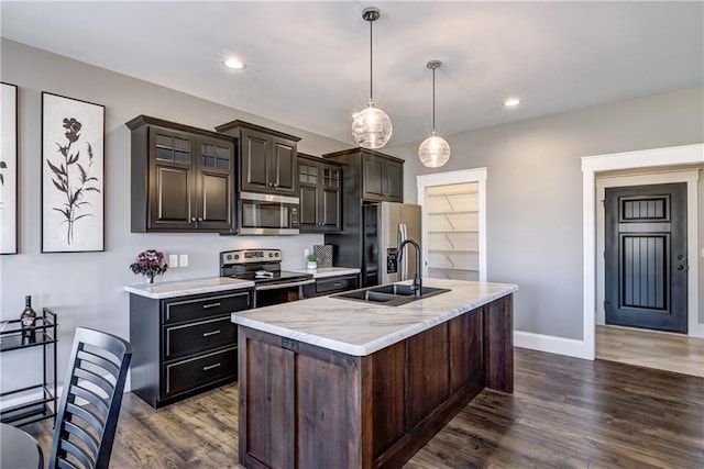 6468 Aspen Ridge Dr, Eau Claire, WI 54703 - kitchen with dark wood-style floors, a sink, light countertops, an island with sink, and appliances with stainless steel finishes