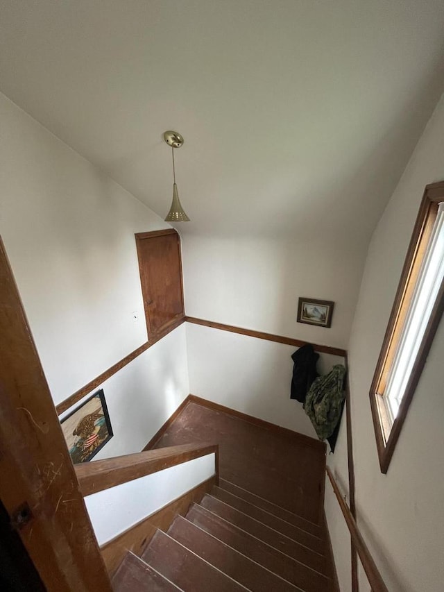 stairway featuring baseboards