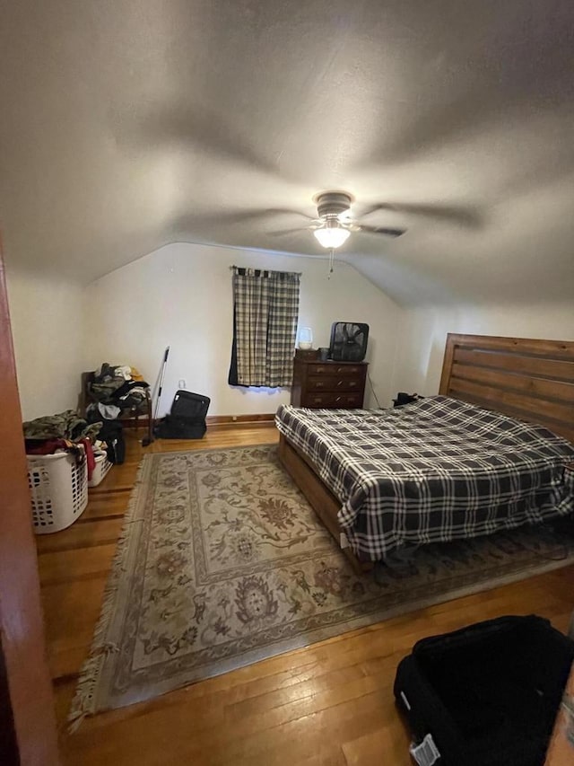 bedroom with wood-type flooring, lofted ceiling, and ceiling fan