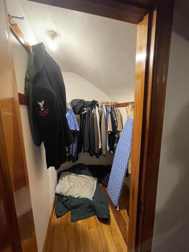 spacious closet featuring vaulted ceiling and wood finished floors