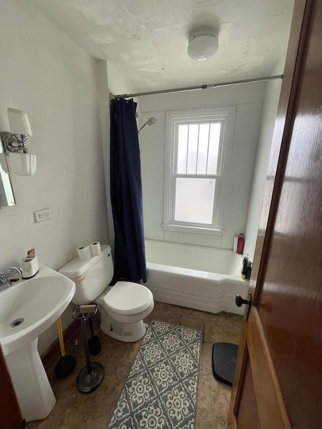 bathroom with shower / bath combo and toilet