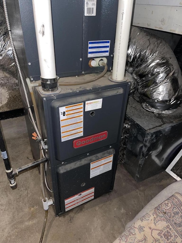 utility room featuring heating unit