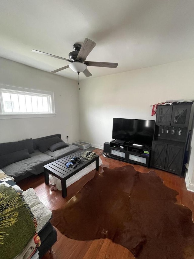 living room with ceiling fan and wood finished floors