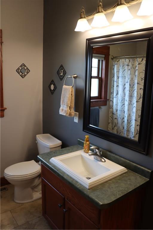 925 Bluff View Cir, Chippewa Falls, WI 54729 - bathroom featuring vanity, tile patterned flooring, and toilet