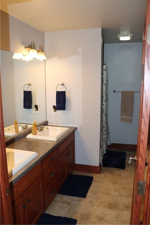 925 Bluff View Cir, Chippewa Falls, WI 54729 - bathroom with baseboards, a sink, and double vanity