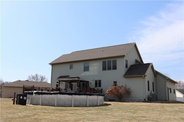 925 Bluff View Cir, Chippewa Falls, WI 54729 - rear view of house featuring a lawn, a covered pool, a gazebo, and central AC unit