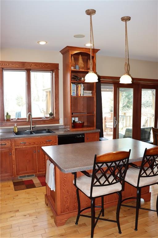 925 Bluff View Cir, Chippewa Falls, WI 54729 - kitchen featuring a wealth of natural light, open shelves, and light wood-type flooring