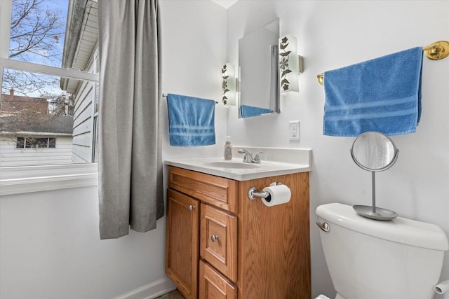 half bathroom with vanity and toilet