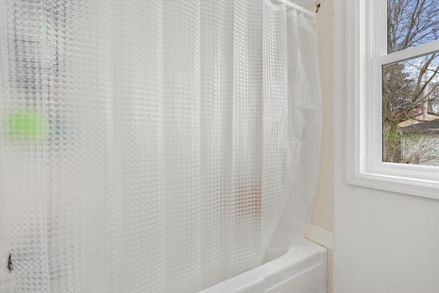 bathroom with shower / tub combo with curtain