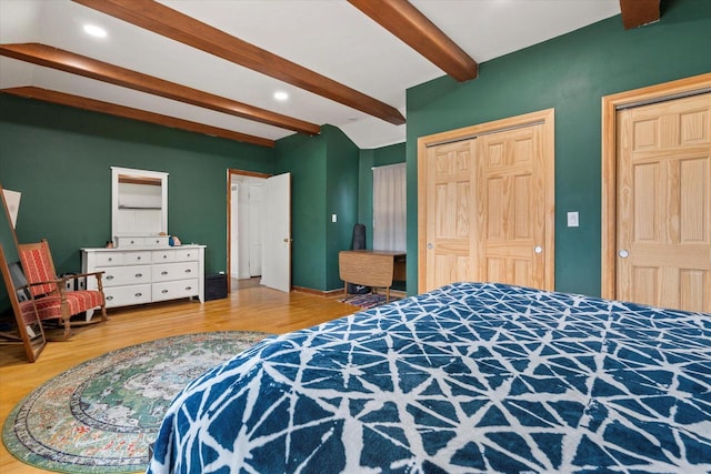 bedroom featuring recessed lighting, a closet, wood finished floors, and beam ceiling