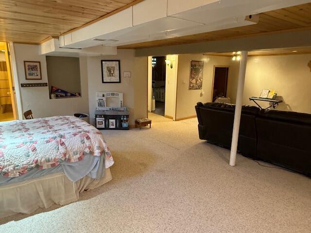 bedroom with carpet and wood ceiling