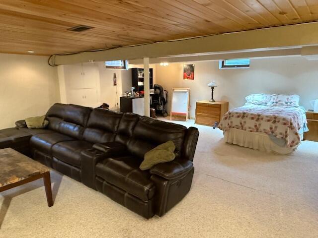 carpeted living room featuring wood ceiling and visible vents