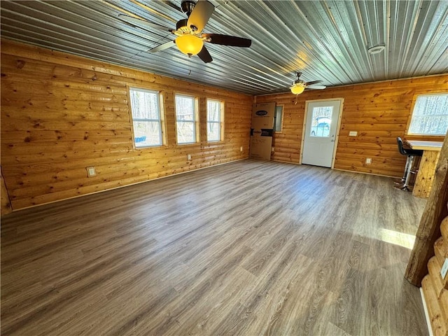 4607N Koeppler Rd, Ojibwa, WI 54862 - unfurnished living room featuring plenty of natural light, wood finished floors, ceiling fan, wood walls, and wooden ceiling