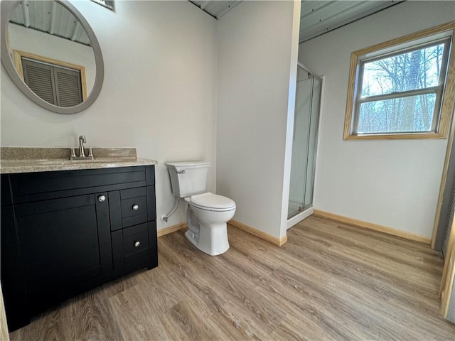 4607N Koeppler Rd, Ojibwa, WI 54862 - full bathroom featuring wood finished floors, vanity, toilet, and a shower stall