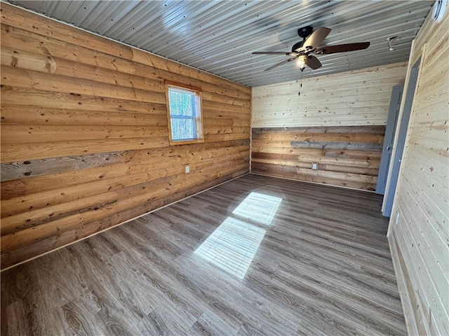 4607N Koeppler Rd, Ojibwa, WI 54862 - spare room with a ceiling fan, wood finished floors, and wood walls