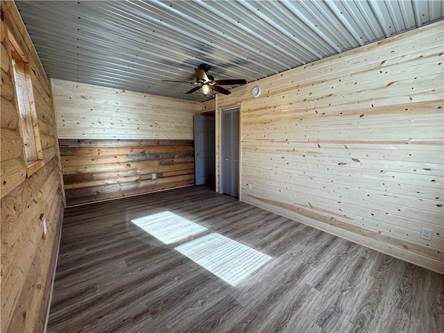 4607N Koeppler Rd, Ojibwa, WI 54862 - empty room featuring wood finished floors, wood walls, and ceiling fan