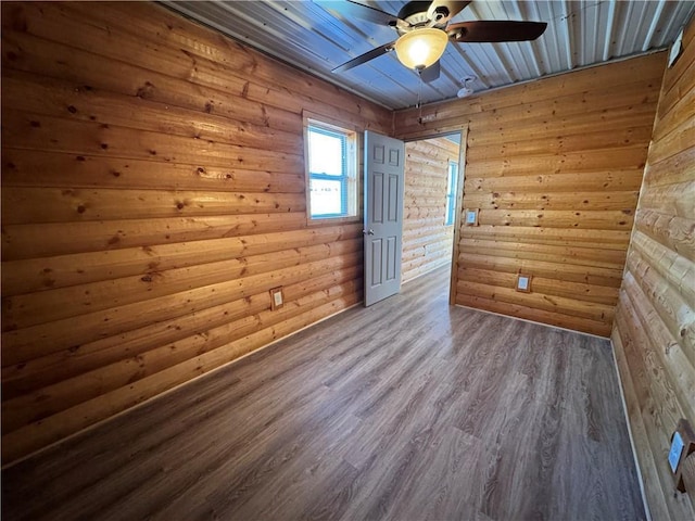 4607N Koeppler Rd, Ojibwa, WI 54862 - spare room with ceiling fan, wood finished floors, and wood walls