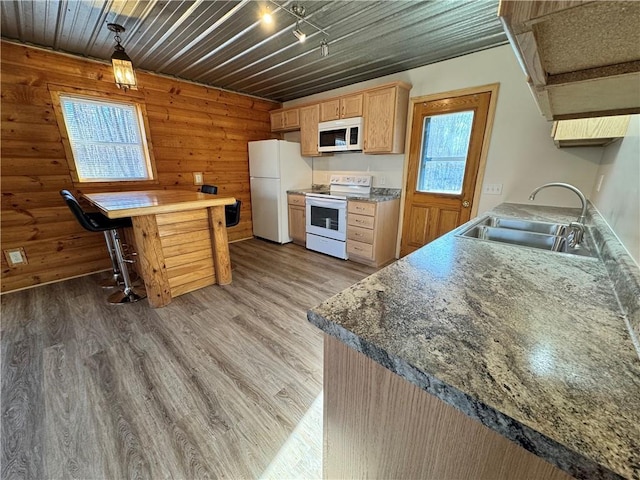 4607N Koeppler Rd, Ojibwa, WI 54862 - kitchen featuring white appliances, a sink, light wood-style floors, wooden walls, and light brown cabinets