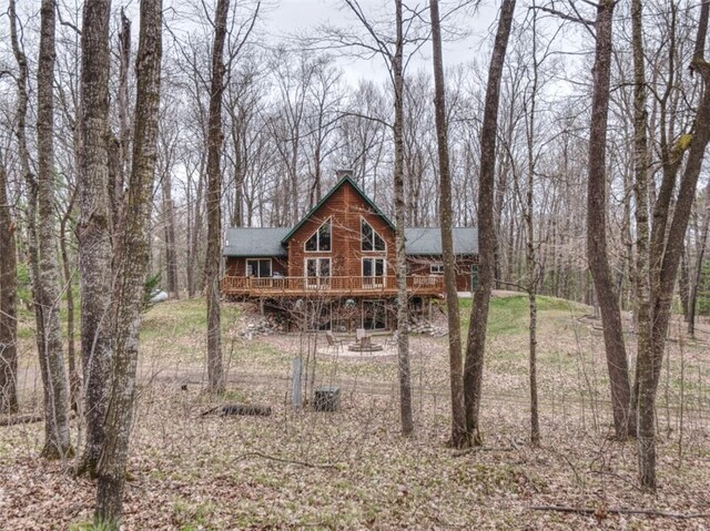 view of front of property with roof with shingles and a deck