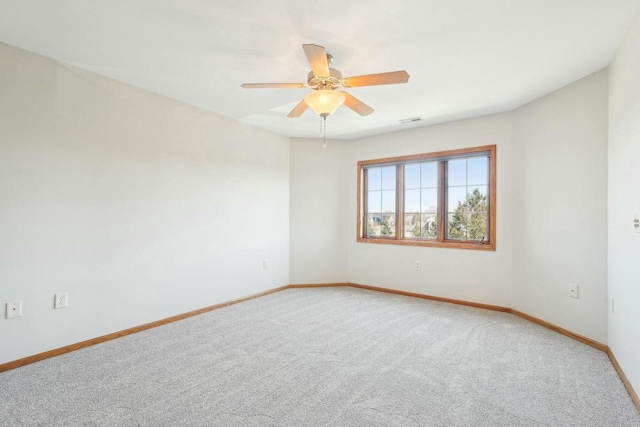unfurnished room featuring ceiling fan, light carpet, visible vents, and baseboards