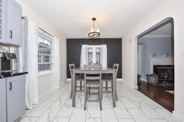 6216 N Santa Monica Blvd, Whitefish Bay, WI 53217 - dining room featuring marble finish floor, arched walkways, baseboards, and a fireplace