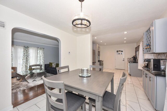 6216 N Santa Monica Blvd, Whitefish Bay, WI 53217 - dining space featuring recessed lighting, marble finish floor, visible vents, arched walkways, and a chandelier