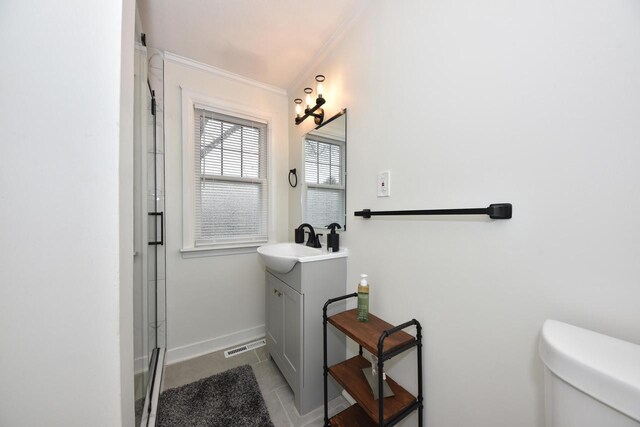 6216 N Santa Monica Blvd, Whitefish Bay, WI 53217 - bathroom with tile patterned flooring, toilet, vanity, ornamental molding, and baseboards
