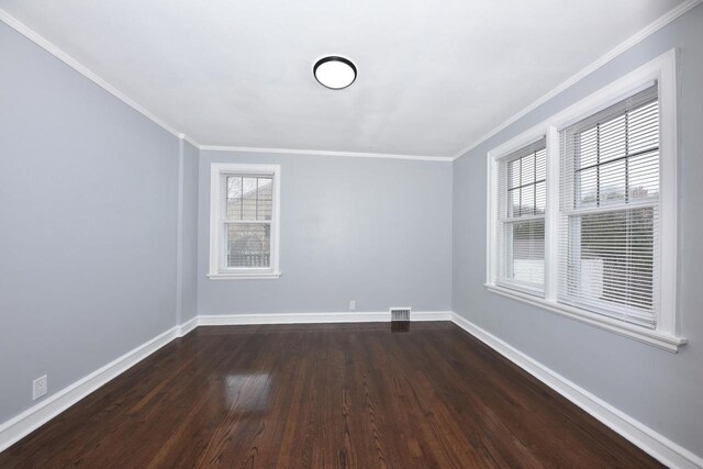 6216 N Santa Monica Blvd, Whitefish Bay, WI 53217 - empty room featuring dark wood finished floors, visible vents, baseboards, and ornamental molding