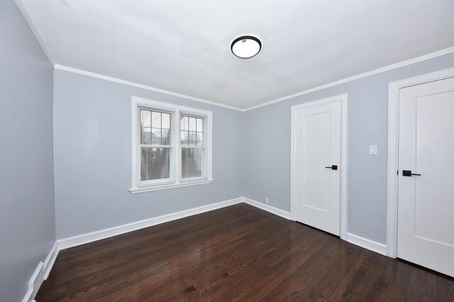 6216 N Santa Monica Blvd, Whitefish Bay, WI 53217 - unfurnished room featuring baseboards, ornamental molding, and dark wood-style flooring