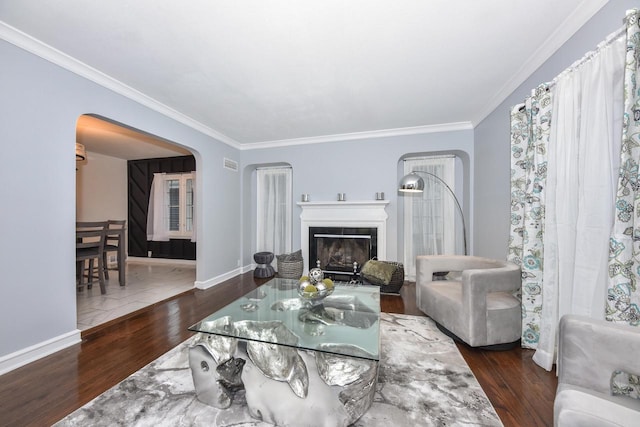 6216 N Santa Monica Blvd, Whitefish Bay, WI 53217 - living area with a fireplace, wood finished floors, arched walkways, and ornamental molding