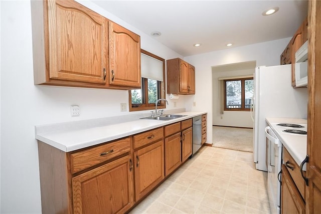 1613 Chumas Dr, Eau Claire, WI 54701 - kitchen featuring a sink, recessed lighting, white appliances, brown cabinets, and light countertops