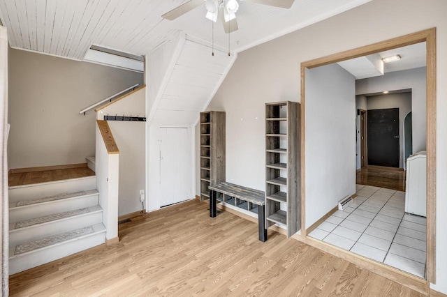 staircase with ceiling fan, baseboards, wood finished floors, and visible vents