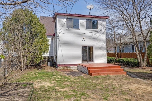 back of property featuring a yard, central AC unit, fence, and a deck