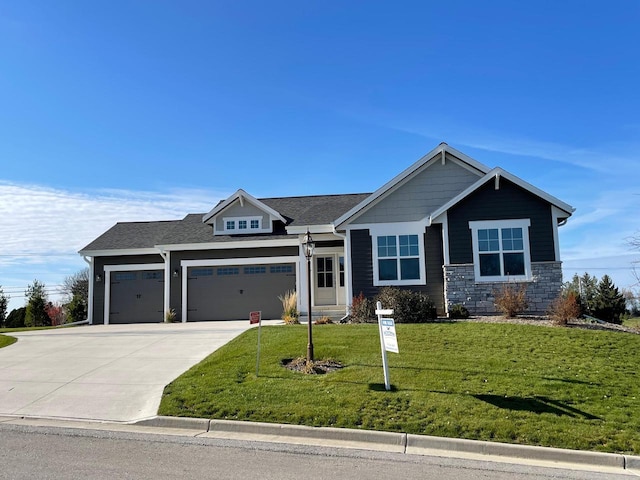 W255S5377 Primrose Ln, Waukesha, WI 53189 - craftsman house featuring roof with shingles, stone siding, concrete driveway, a garage, and a front yard