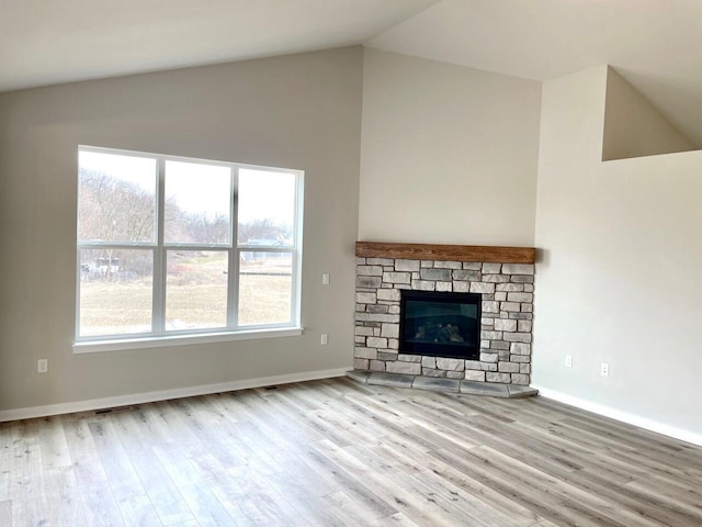 W255S5377 Primrose Ln, Waukesha, WI 53189 - unfurnished living room featuring baseboards, a fireplace, wood finished floors, and high vaulted ceiling