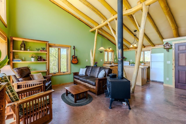 5664 N Dutch Hollow Rd, Potosi, WI 53820 - living area with beamed ceiling, concrete floors, a wood stove, high vaulted ceiling, and baseboards