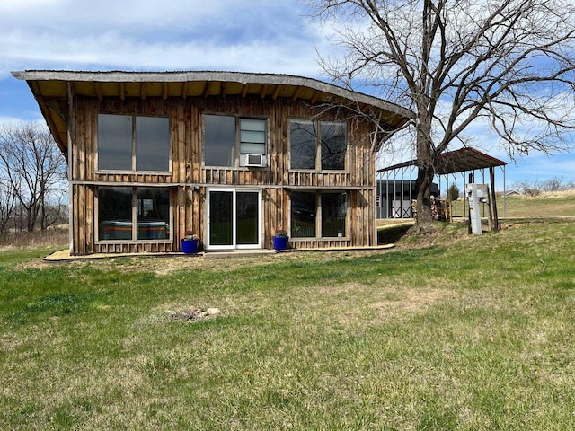 rear view of house with a lawn and cooling unit
