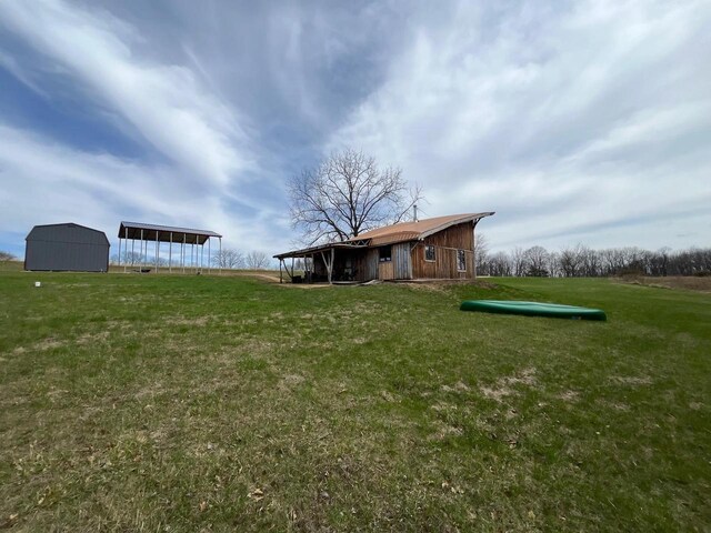 5664 N Dutch Hollow Rd, Potosi, WI 53820 - view of green lawn with a carport and an outbuilding