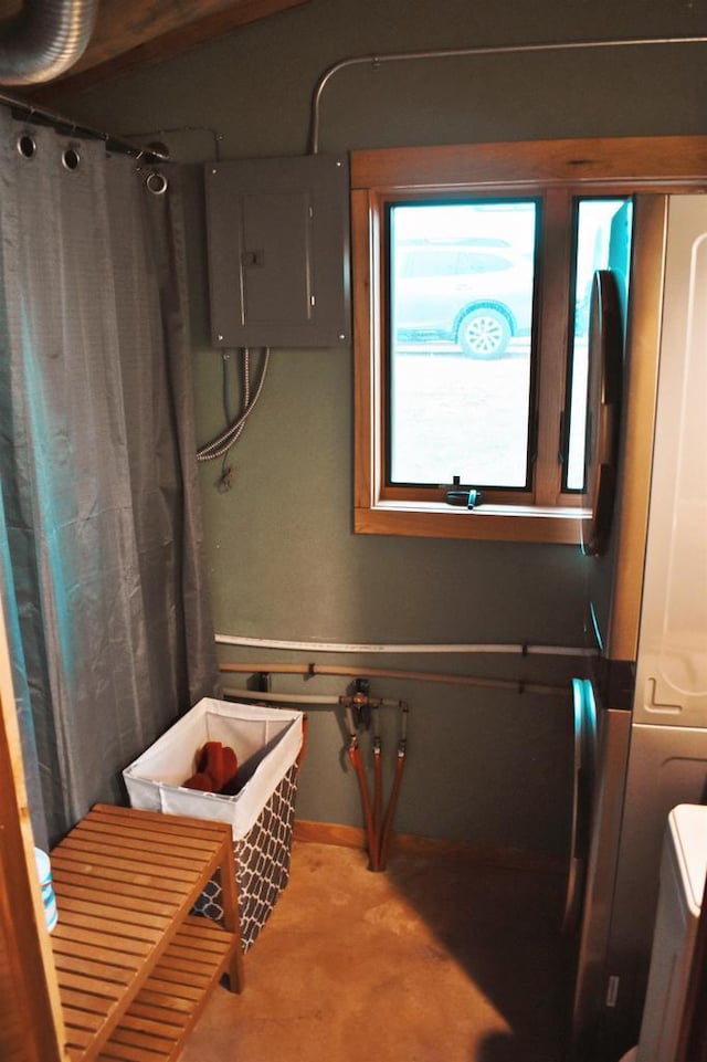 5664 N Dutch Hollow Rd, Potosi, WI 53820 - bathroom with electric panel, concrete floors, baseboards, and curtained shower