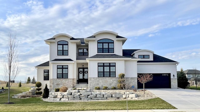 4922 Saint Annes Dr, Waunakee, WI 53597 - view of front facade featuring concrete driveway, stucco siding, stone siding, and a garage
