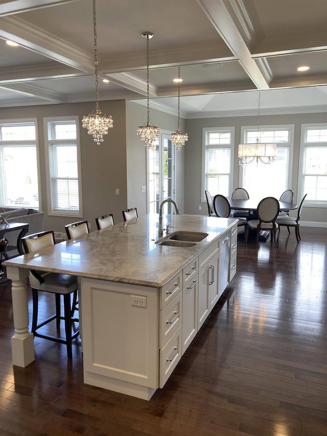 4922 Saint Annes Dr, Waunakee, WI 53597 - kitchen with white cabinets, an inviting chandelier, a sink, a kitchen bar, and coffered ceiling