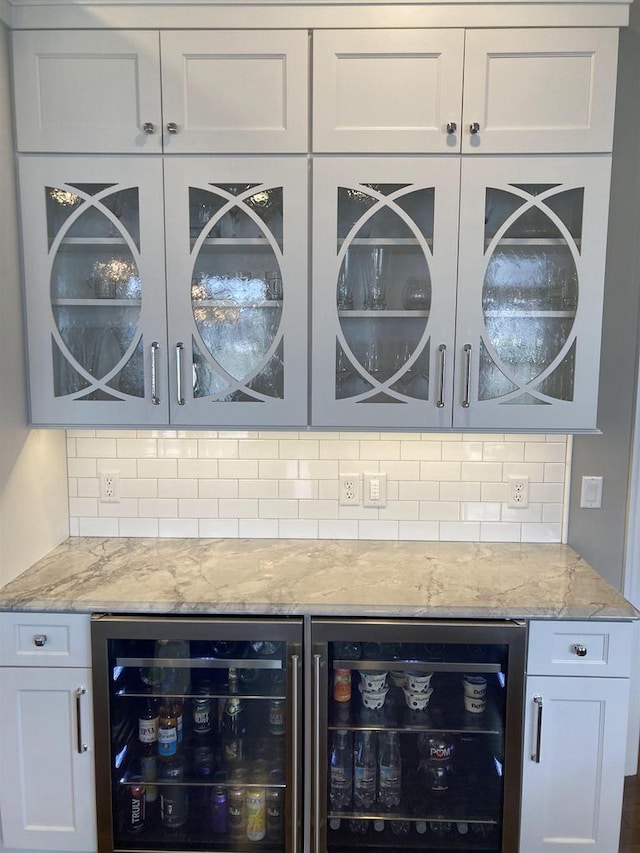 4922 Saint Annes Dr, Waunakee, WI 53597 - bar featuring beverage cooler, decorative backsplash, and a dry bar