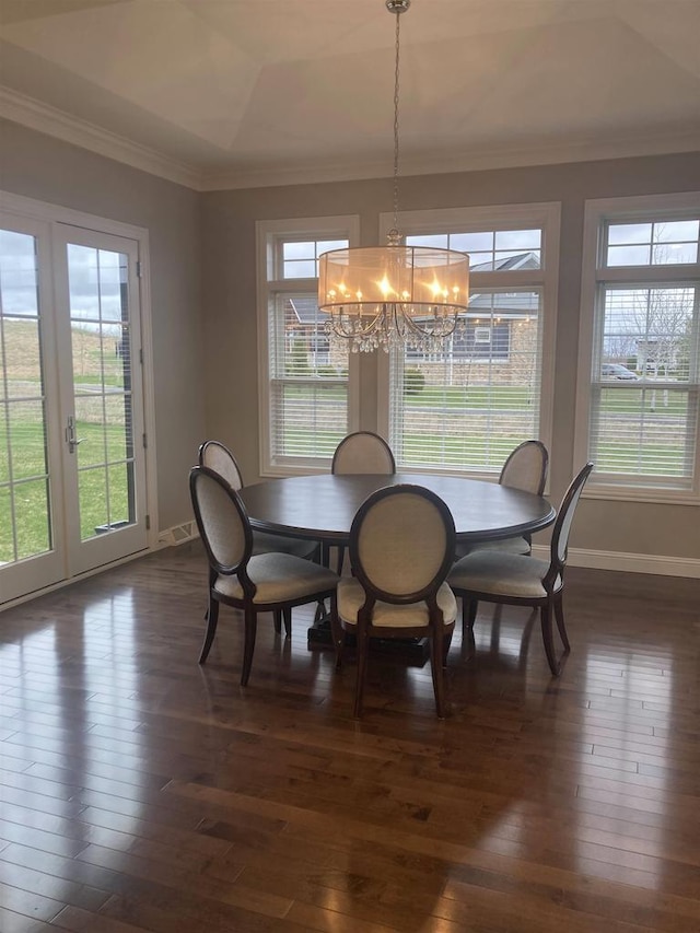 4922 Saint Annes Dr, Waunakee, WI 53597 - dining space with plenty of natural light, crown molding, baseboards, dark wood-style floors, and an inviting chandelier