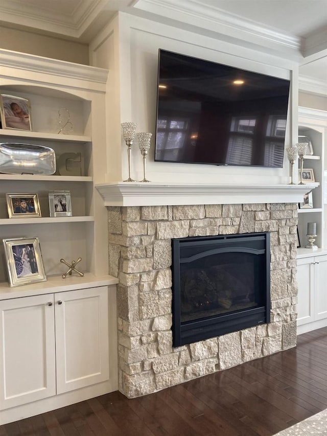 4922 Saint Annes Dr, Waunakee, WI 53597 - interior details featuring built in shelves, a stone fireplace, ornamental molding, and wood finished floors
