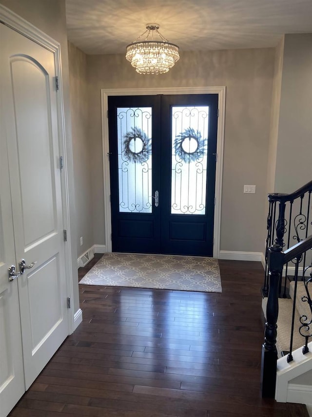 4922 Saint Annes Dr, Waunakee, WI 53597 - entrance foyer featuring baseboards, visible vents, wood-type flooring, and a chandelier