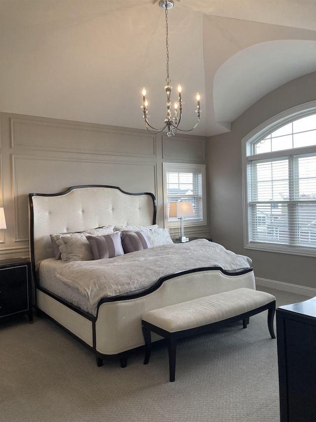 4922 Saint Annes Dr, Waunakee, WI 53597 - bedroom with a notable chandelier, multiple windows, vaulted ceiling, and light carpet
